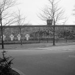the_wall_in_berlin_with_white_crosses_on_fence_1988