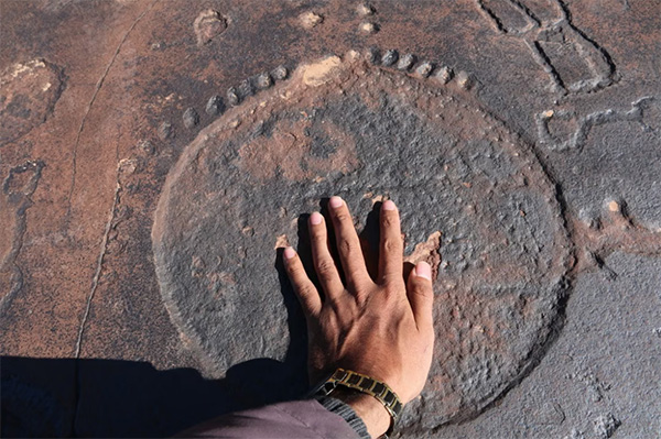 hand-touching-ancient-rock